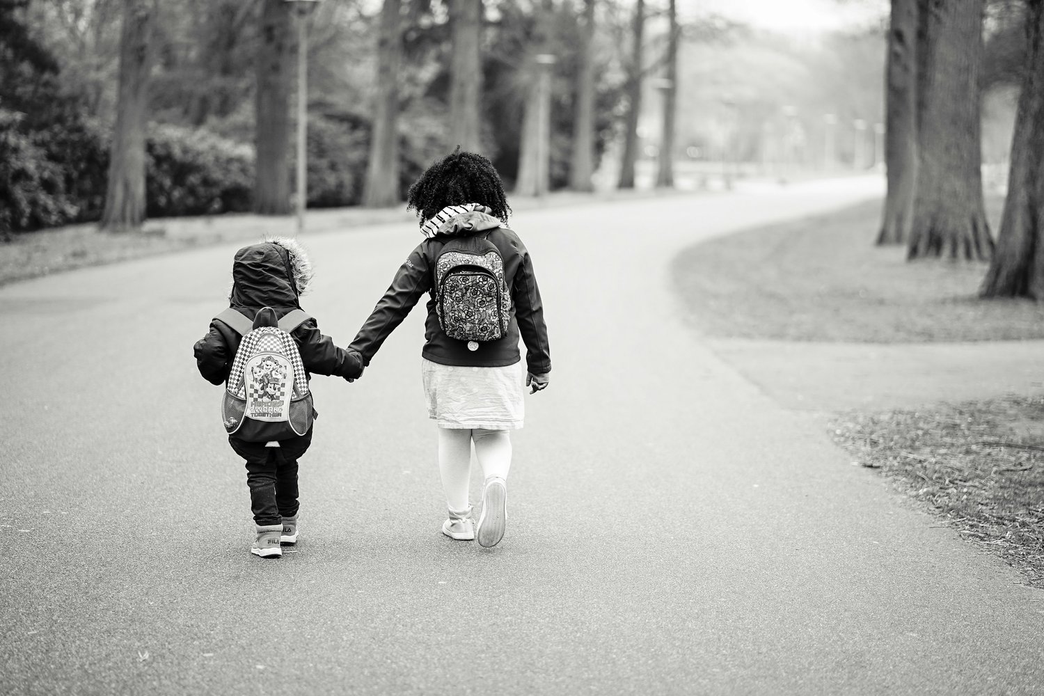 Kids walking hand in hand.