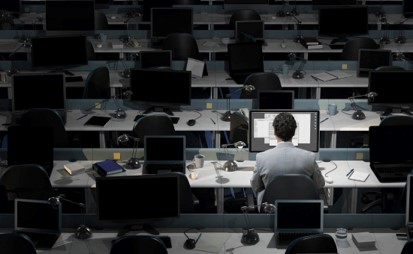 One guy working late in a deserted work space.